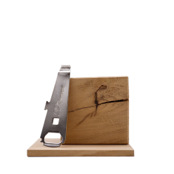 A bottle opener resting on a wooden block next to a knife