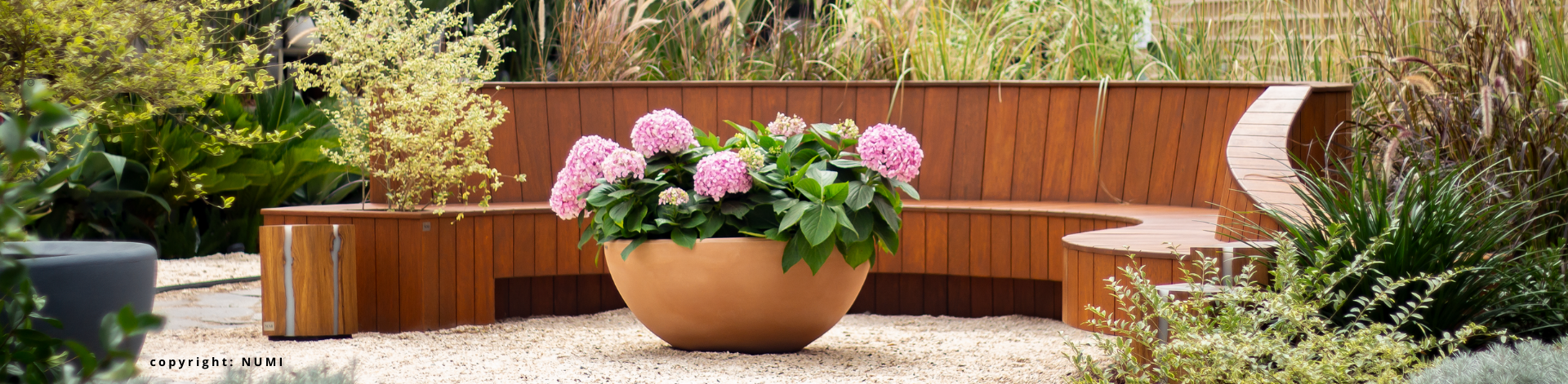 wooden garden furniture in a colorful garden